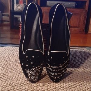 Black suede loafers with golden stars